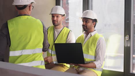 Male-Architects-in-Helmets-Meeting-at-Office