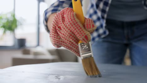 Hands-Painting-Old-Wooden-Table-with-Grey-Color