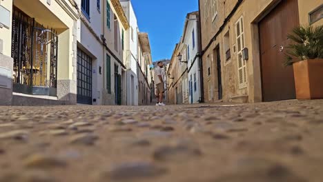 man-walking-through-the-streets-of-the-Mallorca-town-Capdepera