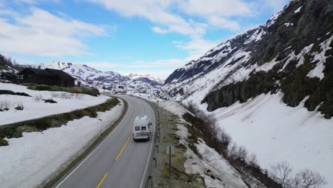 Van-journey-on-the-winding-road-in-the-valley-with-open-blue-sky