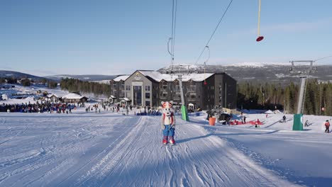 Mascot-taking-the-lift-in-a-ski-area-in-Sweden