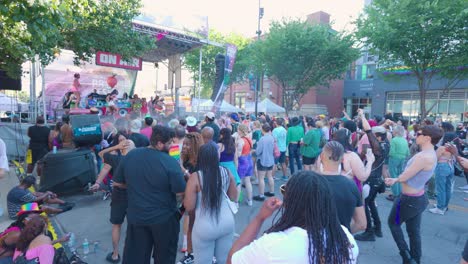 Vibrant-Pride-Festival-Crowd-Celebrating-Under-the-Summer-Sky-The-crowd,-adorned-in-rainbow-patterns,-gathers-under-the-open-sky-to-celebrate-at-gay-pride