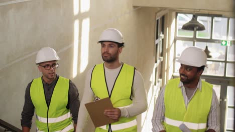 Builder-in-Helmet-with-Clipboard-Walking-Upstairs