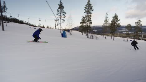 Male-skier-doing-carving-turns-on-a-slope-with-forest-all-around