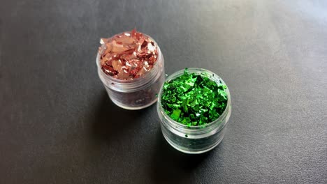 Close-up-of-applying-shimmer-glitter-from-the-packaging,-illustrating-the-use-of-various-painting-supplies-for-facial-skin-decoration