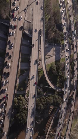 American-Highway-Junction-and-Interchange,-Vertical-Aerial-View,-Flying-Above-Traffic-and-Elevated-Roads