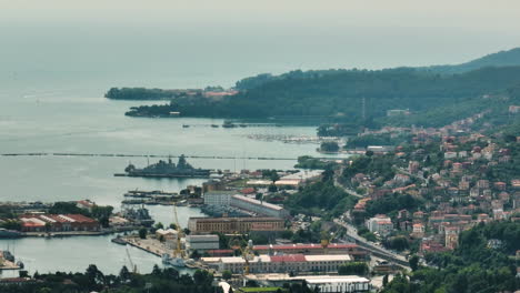 La-spezia,-italy,-showing-the-coastline-and-buildings-by-the-harbor,-aerial-view