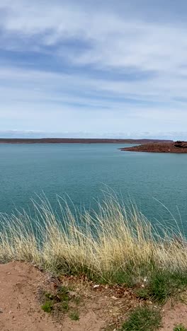 Calm-turquoise-lake-with-clear-sky-and-distant-shoreline