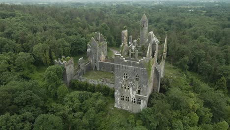 Ruins-Of-The-Gothic-Revival-Style-Of-Dromore-Castle-Surrounded-By-Lush-Greenery-In-County-Limerick,-Ireland