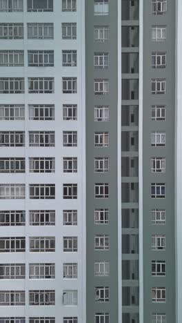 Large-Hi-Rise-Residential-Building-Facades-Aerial-View-with-drone-flying-or-zooming-in-towards-subject-in-vertical-format