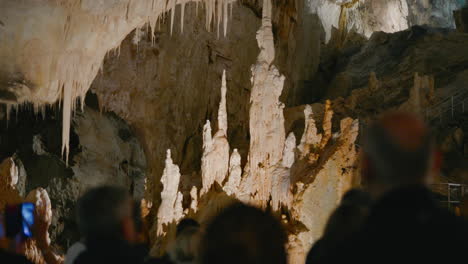 Frasassi-Caves,-guided-exploration-of-the-caves-inside-imposing-stalactites-and-stalagmites-and-underground-passages