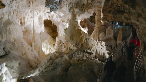 Frasassi-Caves,-guided-exploration-of-the-underground-caves-full-of-stalactites-and-stalagmites-of-very-white-rock