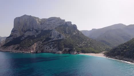 Mediterranean-Beach-Landscape-Surrounded-By-Large-Mountains-In-Sardinia,-Italy