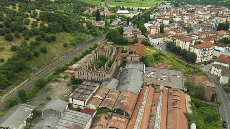 Abandoned-ceramic-factory-in-lush-Italian-countryside,-aerial-view