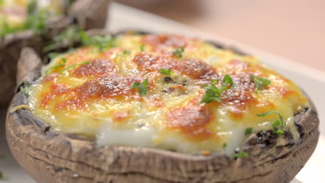 Macro-shot-putting-parsley-on-gratin-portobello-mushrooms,-plating-close-up