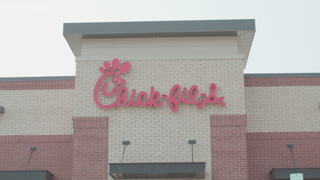 Entrance-sign-for-Chick-Fil-A-in-Okemos,-Michigan-with-stable-video-shot