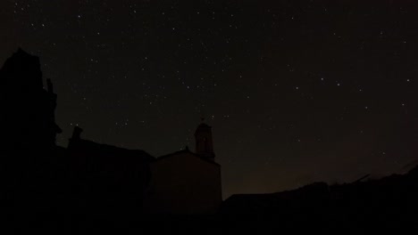 Stars-in-night-sky-time-lapse-with-old-church-building,-Italy