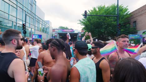 Vibrant-Pride-Festival-Crowd-Celebrating-Under-the-Summer-Sky-The-crowd,-adorned-in-rainbow-patterns,-gathers-under-the-open-sky-to-celebrate-at-gay-pride