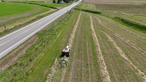 A-farmer-rakes-hay-in-Northeast-Wisconsin-making-it-ready-for-baling