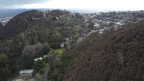 4K-Drone-shot-flying-over-a-mountain-towards-a-small-Australian-town-in-Tasmania