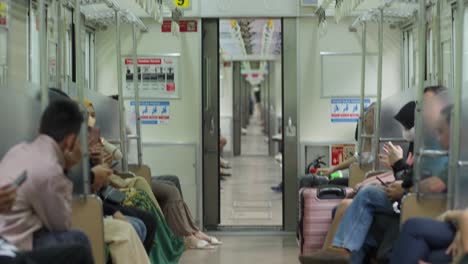 Passengers-On-Train-Departing-From-Rawa-Buntu-Station-In-Serpong,-South-Tangerang,-Indonesia