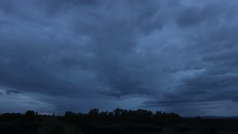 A-time-lapse-of-dark-clouds-moving-over-a-nature-preserve,-showcasing-the-dramatic-and-ever-changing-sky,-highlighting-the-preserve’s-serene-landscape-and-natural-beauty