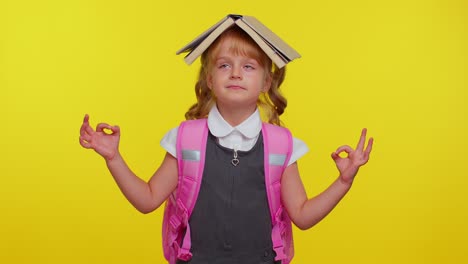 Teenage-girl-in-school-uniform-putting-book-on-head,-meditating,-relaxing-with-concentrated-thoughts