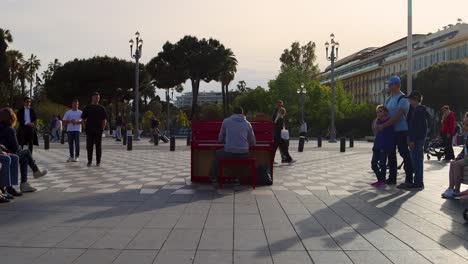 Street-performer-plays-piano-at-city-square-Place-Massena-in-Nice,-France