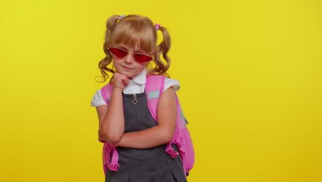 Playful-happy-teen-child-kid-girl-in-school-uniform-winking-eye,-looking-at-camera-with-smile