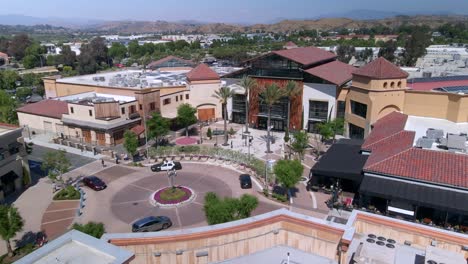 Aerial-view-around-the-roundabout-at-the-Valencia-town-center,-in-sunny-CA,-USA