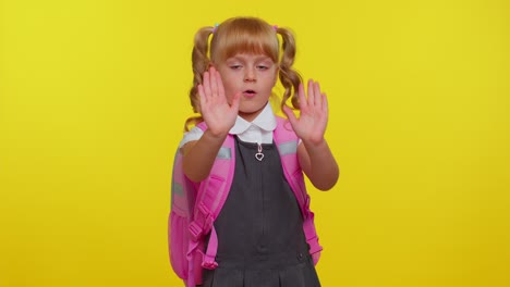 Kid-school-girl-say-no-hold-palm-folded-crossed-hands-in-stop-gesture,-warning-of-finish,-danger