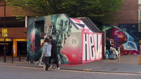 Artist-spray-paints-street-art-mural-in-Manchester’s-Northern-Quarter