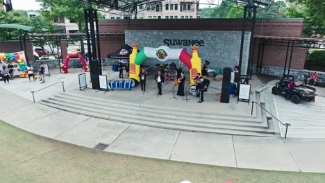 A-Local-Band-Entertains-Attendees-at-the-Tacos-and-Tequila-5K-Race-in-Suwanee,-Georgia,-USA---Pan-Down-Shot