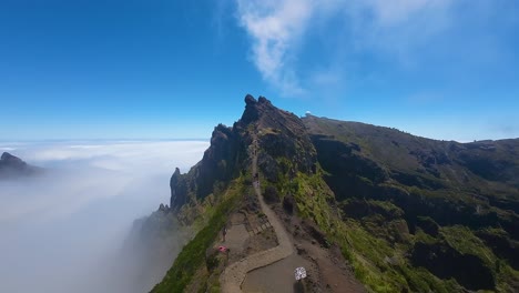 Narrow-hiking-path-leads-trekkers-to-far-away-peak-of-mountain-trail