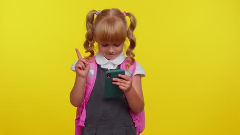 Girl-kid-in-school-uniform-using-mobile-phone-typing-new-post,-sms-message,-browsing-social-networks