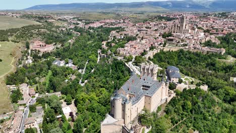 Der-Alcazar-Von-Segovia,-Spanien,-Zieht-Die-Drohnenluftaufnahme-Zurück-Und-Zeigt-Die-Altstadt-Im-Hintergrund