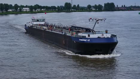 Aerial-View-Of-HYDROVAC-12-Ship-Cruising-River-In-Barendrecht,-Netherlands