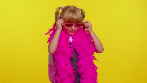 Beautiful-cute-smiling-schoolgirl-with-backpack-wearing-sunglasses,-charming-smile,-posing,-dancing