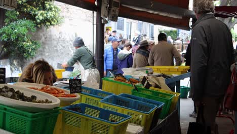 French-Woman-Selling-at-Food-Stall-in-Provencal-Market,-Antibes,-France