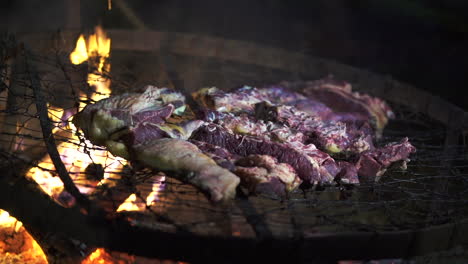 Nighttime-Argentine-asado:-select-cuts-grilling-over-glowing-embers---slow-motion