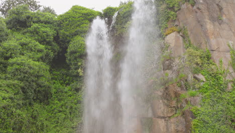 Waterfall-cascades-down-a-lush-green-cliffside-in-Jardin-extraordinaire,-Nantes,-France