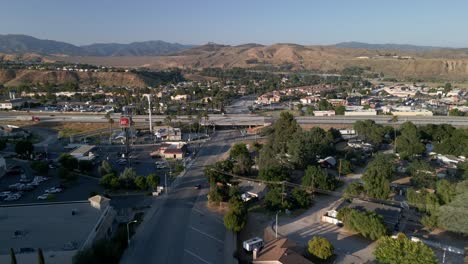 Aerial-view-over-streets-and-a-bridge-in-Castaic,-golden-hour-in-California,-USA