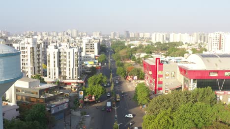 Aerial-drone-view-There-are-many-vehicles-driving-on-the-road-and-many-high-rise-big-buildings