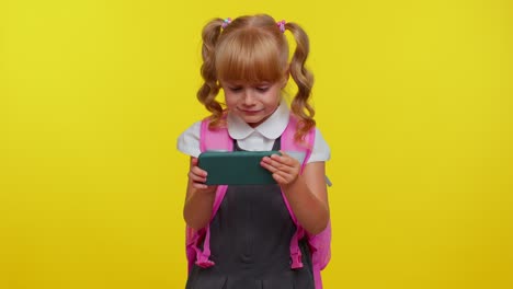 Worried-funny-school-girl-wear-backpack-enthusiastically-playing-racing-video-games-on-mobile-phone