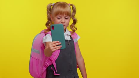 Schoolgirl-kid-blogger-in-uniform-taking-selfie,-recording-video-on-mobile-phone-for-social-media