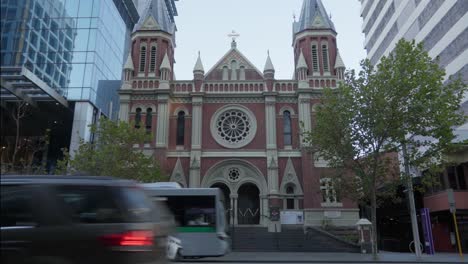 Bus-and-car-drive-through-Historic-Trinity-Unity-Church,-view-from-across-street