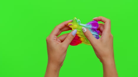 Girl-hands-squeezing-presses-colorful-anti-stress-touch-screen-push-pop-it-toy-game-on-chroma-key