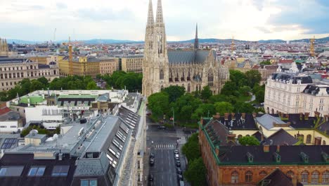 Aerial-frontal-travel-to-Votive-Church-in-Vienna,-Austria