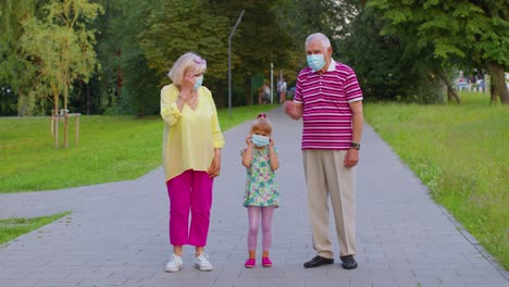 Quarantine-Coronavirus-is-over,-senior-family-grandparents-with-granddaughter-take-off-medical-masks