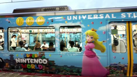 Metro-train-arriving-in-Japan-featuring-colorful-Universal-Studios-Japan-decals